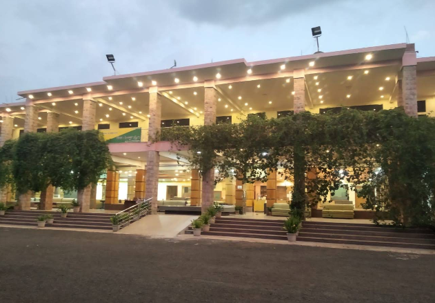 Evening view of the swimming pool and luxury cottages at Kanthi Resorts, the best hotel in Badami Bagalkot